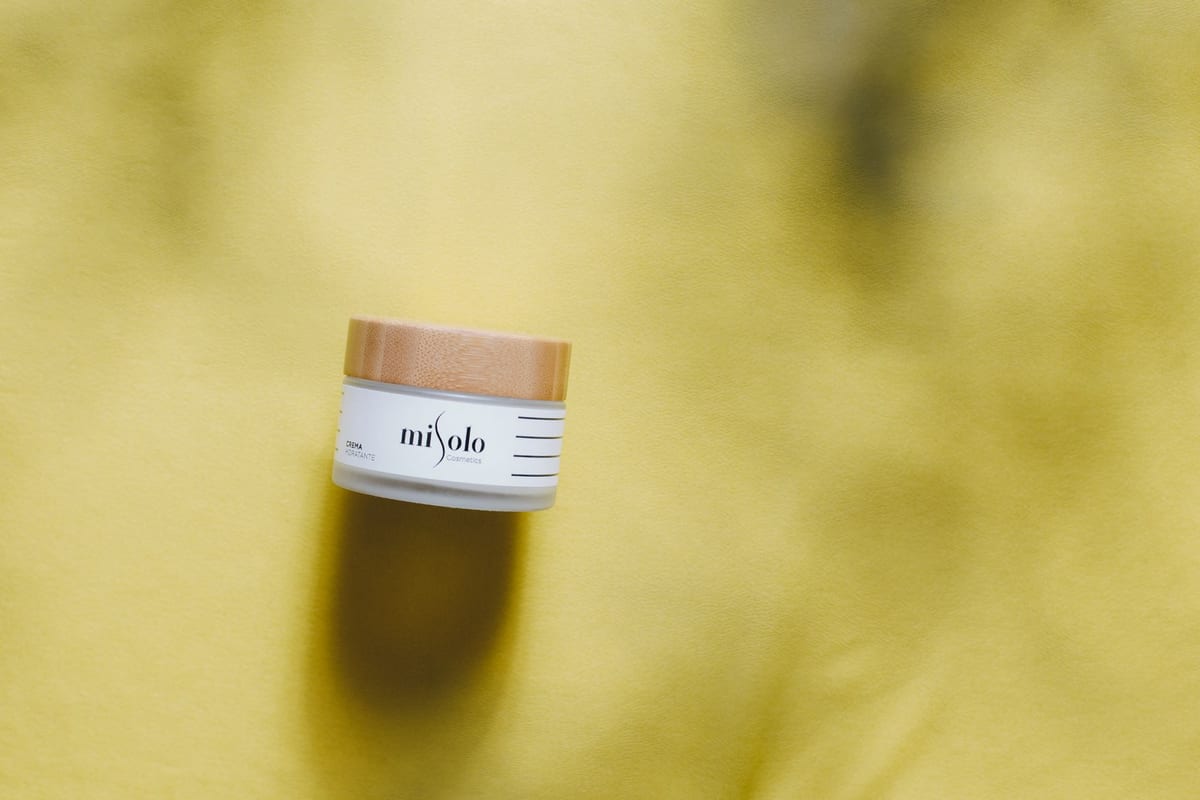 A minimal skincare jar photographed against a plain background